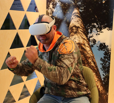 A picture of a man with a VR headset sitting down