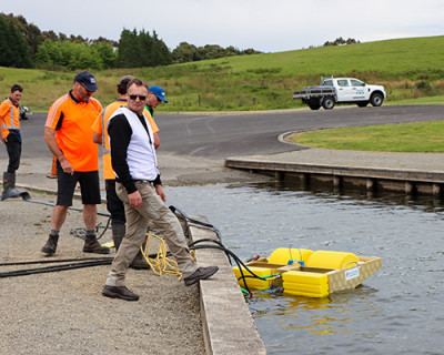 Image of a man standing on the side of a boat ramp