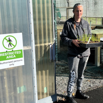 Staff member in green house restricted area