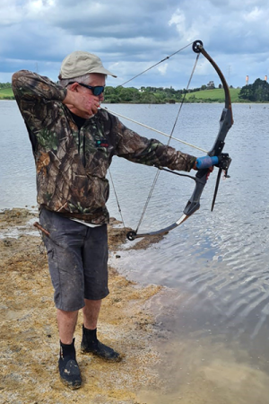 Peter Harrison takes aim at koi carp in the water
