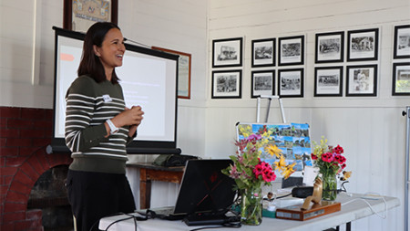 Image of a lady standing up doing a presentation