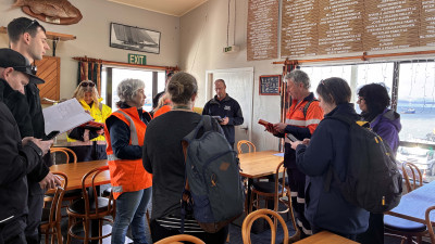 Response team members gathered for a briefing during Exercise Kārewa