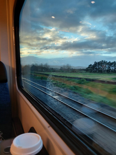 An image looking out of a train window at countryside