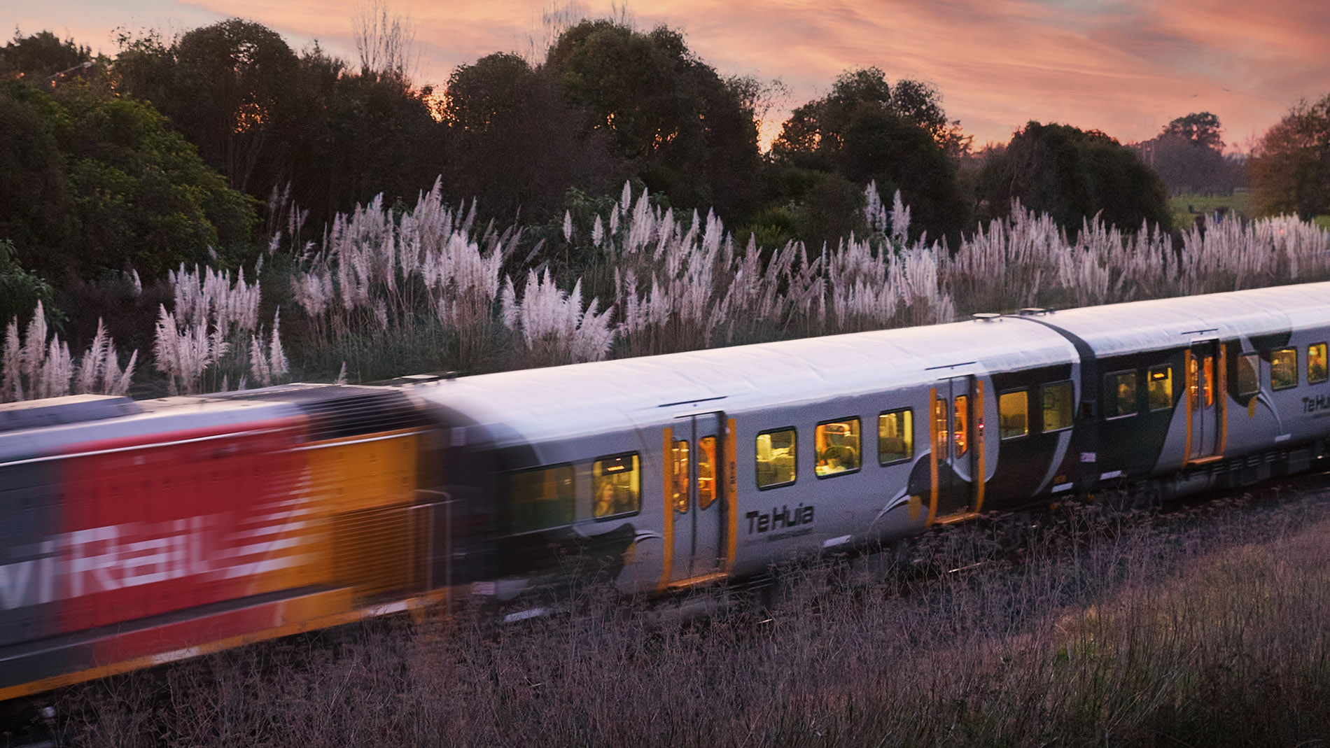 Image of a train on the tracks going through a field