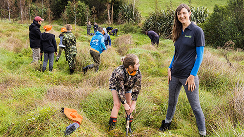 Puahue School students getting stuck into planting a wetland within the project area.