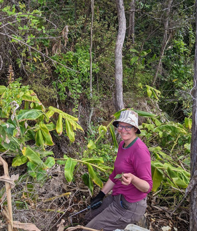 Lady holding leaf in bush