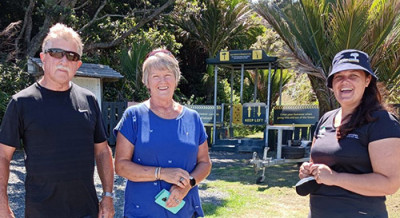 Picture of three people outside the beginning of a track
