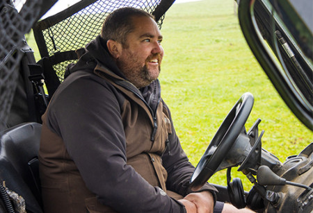 A picture of a man smiling while sitting in a quad bike